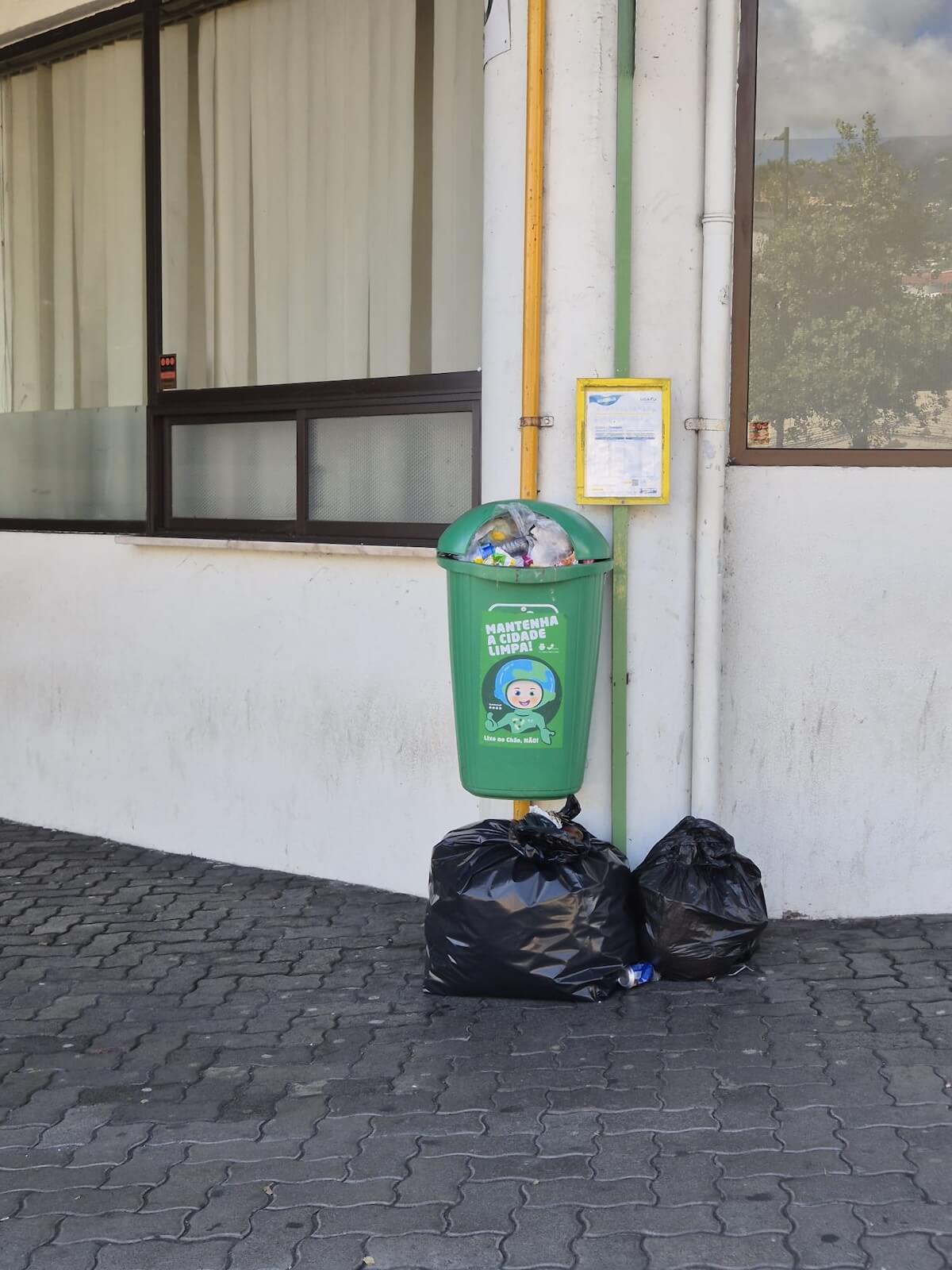 Full waste container with extra bags